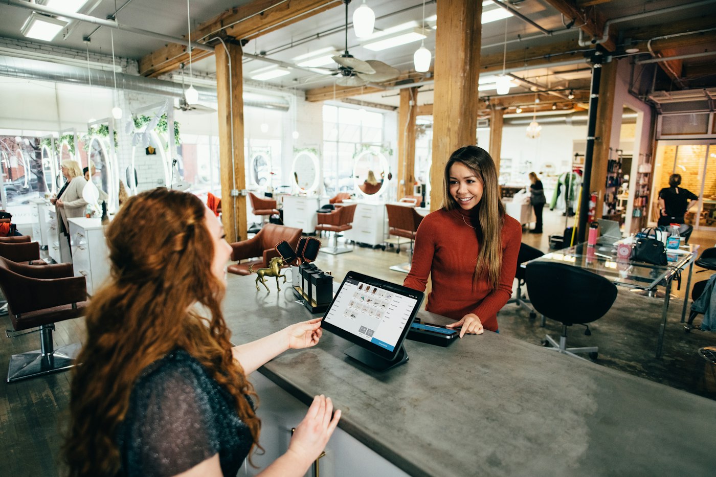 Local business owner helping a customer at the front desk